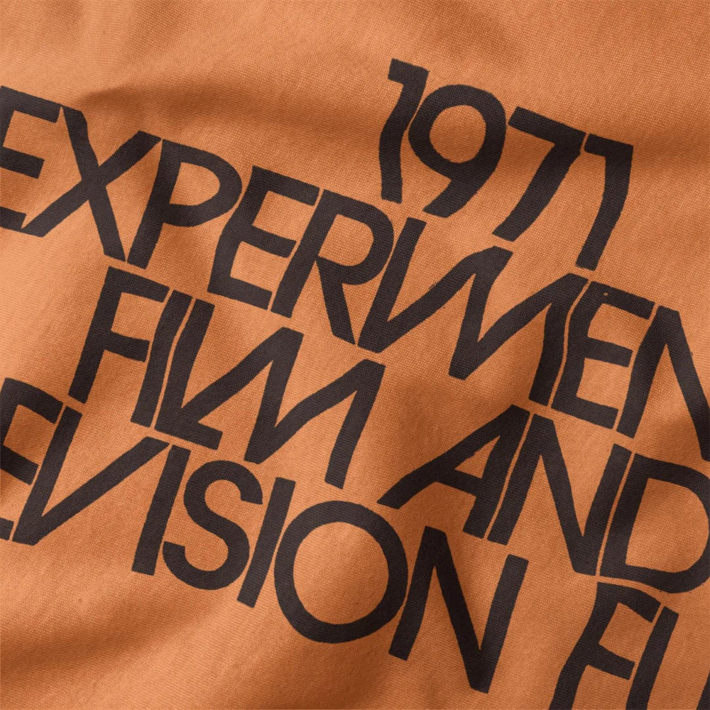 experimental film & television fund classic tee in burnt orange, close-up of the print